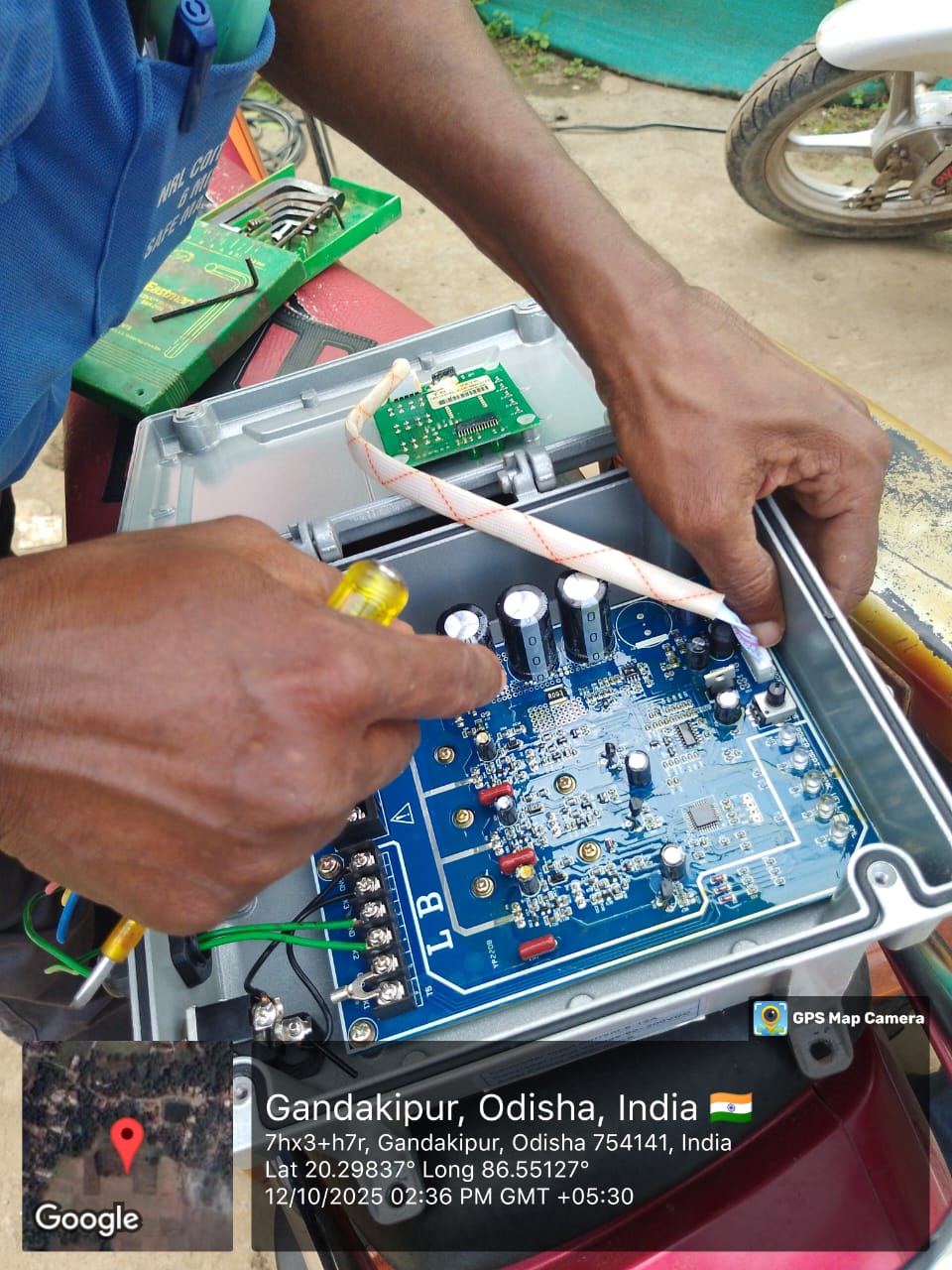 Technician assembling DC controller for RWSS solar pump repair, Gandakipur